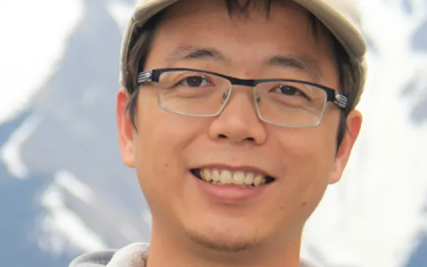 Shujun Ou in front of mountain